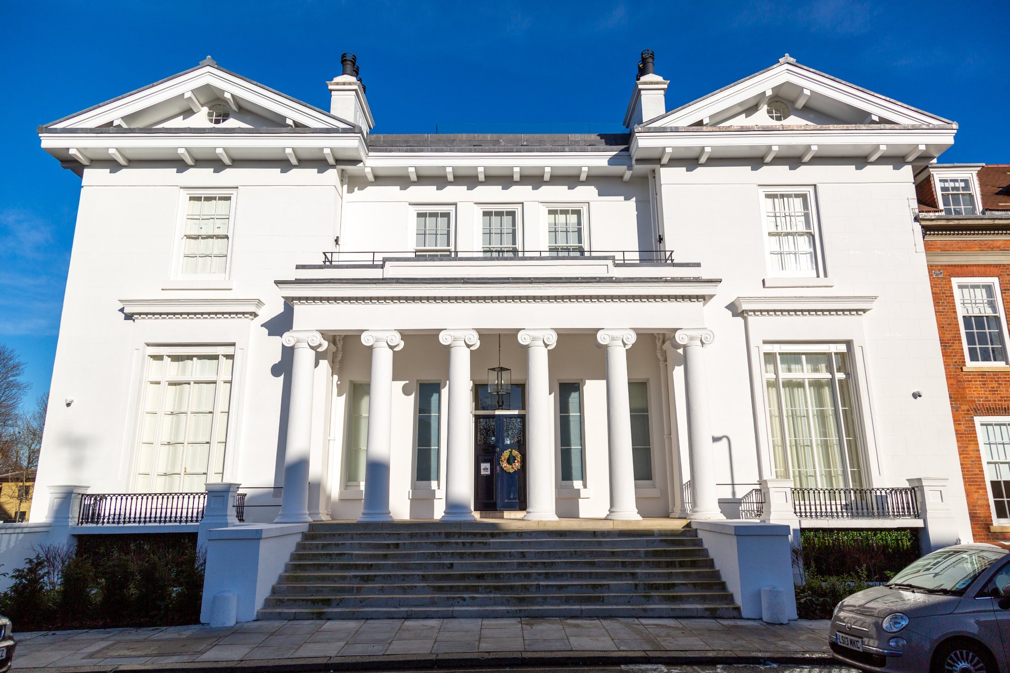 White neoclassical mansion with Ionic columns