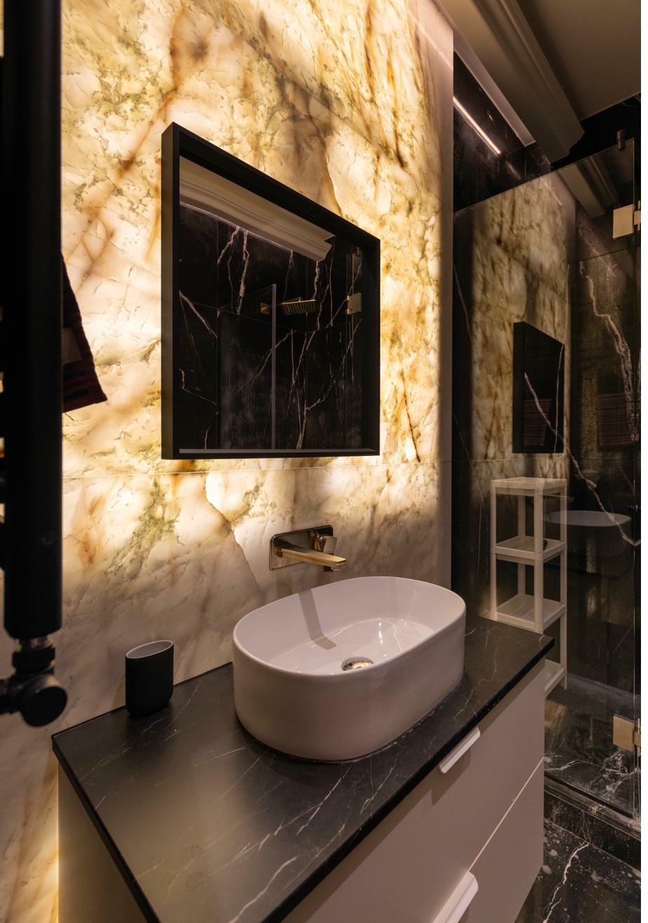 Luxury bathroom with backlit onyx marble and vessel sink