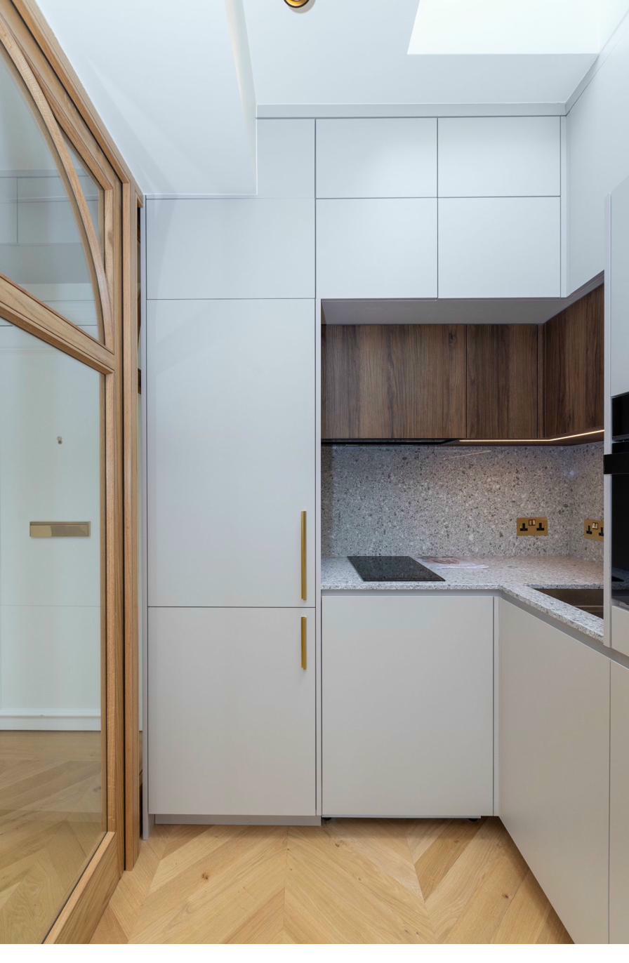 Modern kitchen with white cabinetry and granite worktops