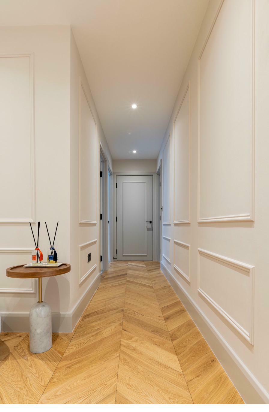 Luxury hallway leading to entrance with recessed lighting
