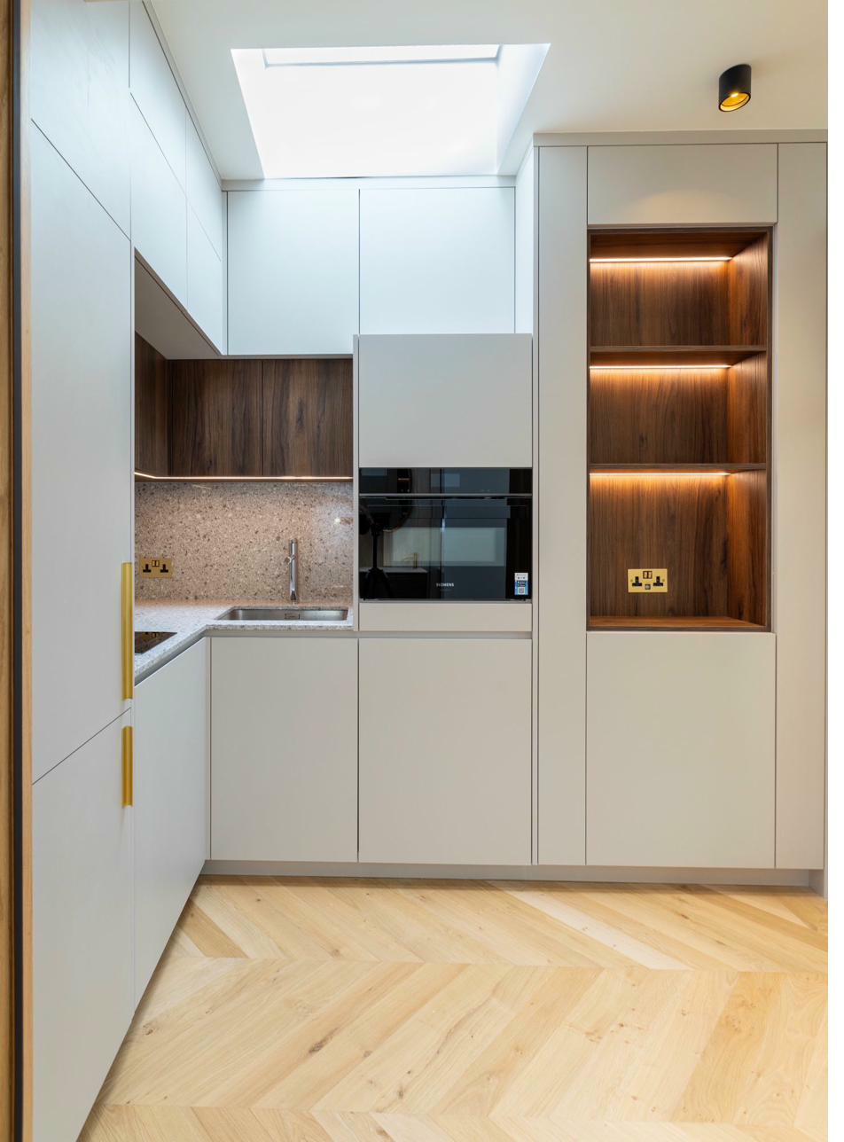 Modern kitchen with walnut accents and skylight