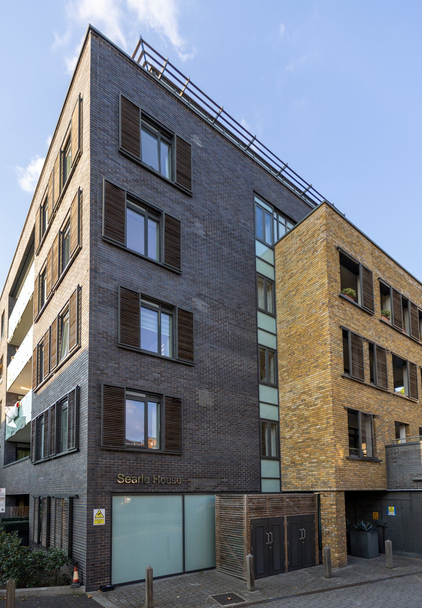 Modern dual brick apartment building at twilight